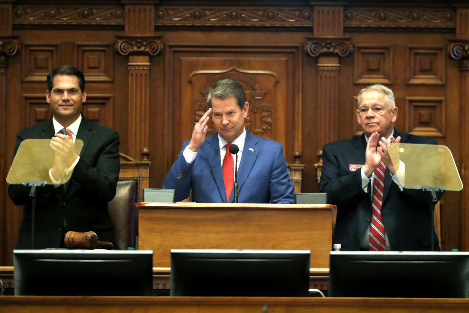 FILE - In this Jan. 16, 2020, file photo, Gov. Brian Kemp, center, is flanked by House Speaker David Ralston, R-Blue Ridge, right, and Lt. Gov. Geoff Duncan as he salutes former U.S. Senator Johnny Isakson, R-Ga., during the State of the State address before a joint session of the Georgia General Assembly in Atlanta. House Bill 757 passed Monday, Jan. 27, out of a House subcommittee. GOP Gov. Brian Kemp has threatened a veto. (AP Photo/John Bazemore, File)