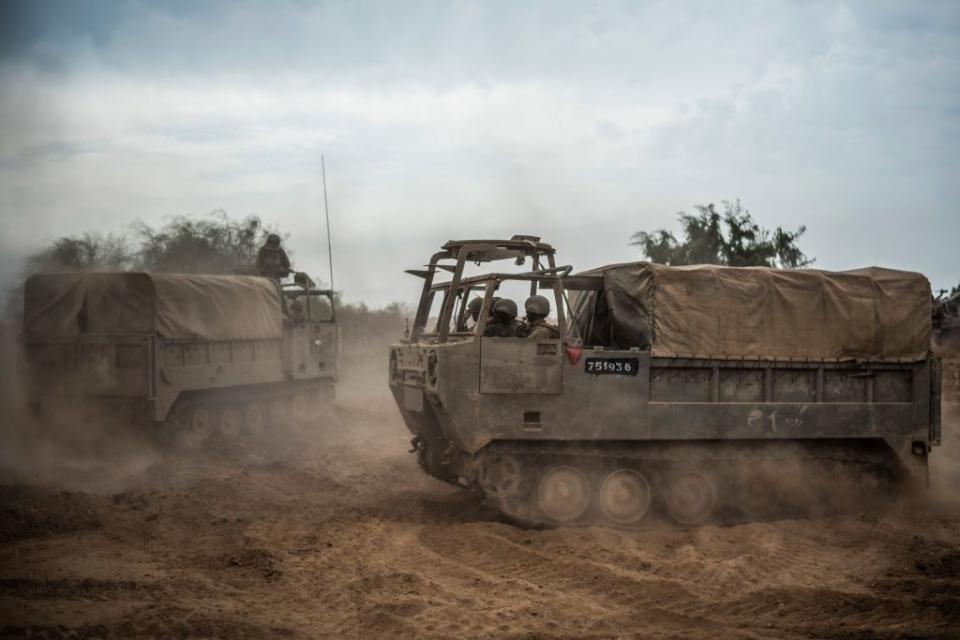 Israeli troops ride in military vehicles near the Israel-Gaza border.