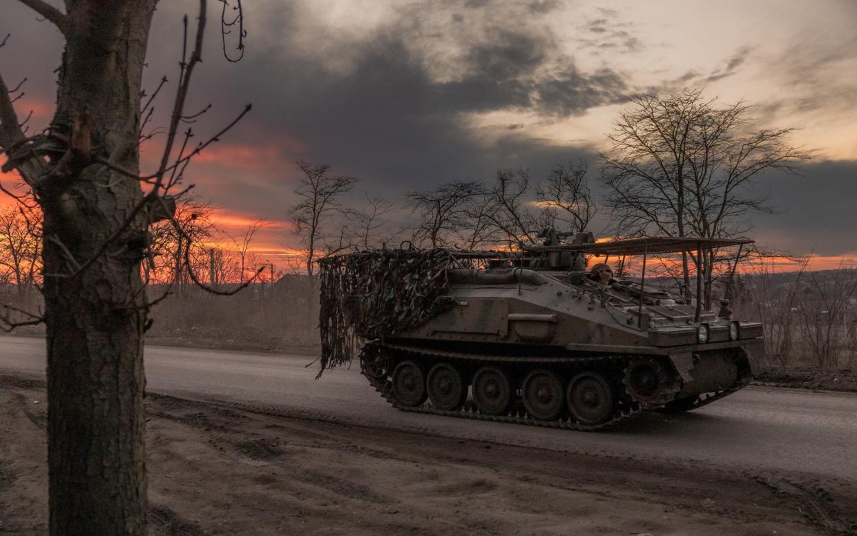 A Ukrainian soldier drives a British FV103 Spartan armoured personnel carrier in the Donetsk region