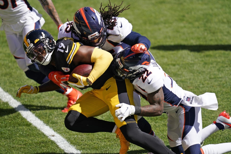 Pittsburgh Steelers wide receiver JuJu Smith-Schuster (19) is tackled by Denver Broncos strong safety Kareem Jackson (22) and linebacker A.J. Johnson during the first half of an NFL football game, Sunday, Sept. 20, 2020, in Pittsburgh. (AP Photo/Keith Srakocic)