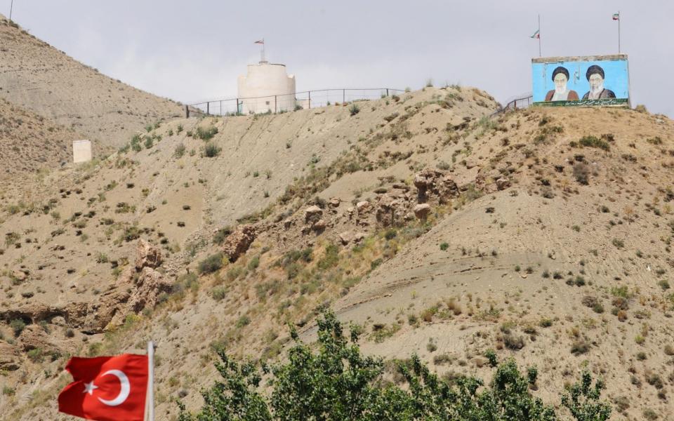 An Iranian poster seen from the Turkish side of the border near the Esendere crossing between the two countries - BULENT KILIC /AFP