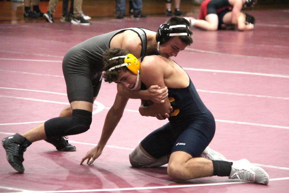 Union City's Maddox Miller sinks in his hooks versus Columbia Central Wednesday. Miller won via pin fall