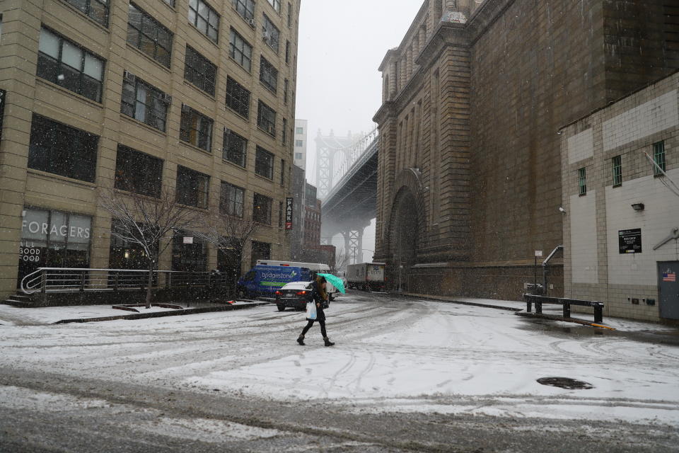 <p>A woman walks the DUMBO section of Brooklyn, New York as the snow gets heavier as a spring storm moved through the area on March 21, 2018. (Photo: Gordon Donovan/Yahoo News) </p>