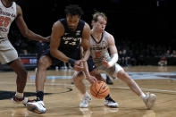 Virginia Tech's Storm Murphy (5) steals the ball from Xavier's Ben Stanley (14) during the first half of an NCAA college basketball game in the NIT Season Tip-Off tournament Friday, Nov. 26, 2021, in New York. (AP Photo/Adam Hunger)