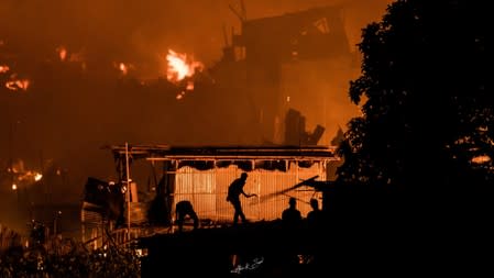 Flames engulf a slum after a fire broke out in Dhaka