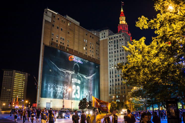 Fans celebrate in front of a LeBron James mural after the Cleveland Cavaliers defeated the Golden State Warriors to win the 2016 NBA Championship. (Angelo Merendino/Getty Images)