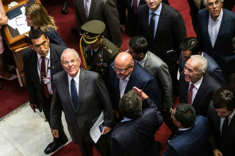 Kuczynski, second from the left, after speaking before lawmakers in Peru's Congress, where he narrowly beat an impeachment vote in December