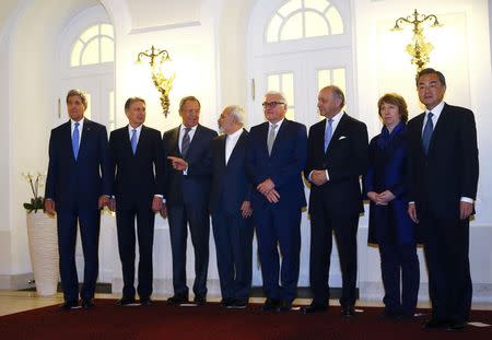 U.S. Secretary of State John Kerry, Britain's Foreign Secretary Philip Hammond, Russian Foreign Minister Sergei Lavrov, Iranian Foreign Minister Javad Zarif, German Foreign Minister Frank-Walter Steinmeier, French Foreign Minister Laurent Fabius, EU envoy Catherine Ashton and Chinese Foreign Minister Wang Yi (LtoR) pose for photographers before a meeting in Vienna November 24, 2014. REUTERS/Leonhard Foeger