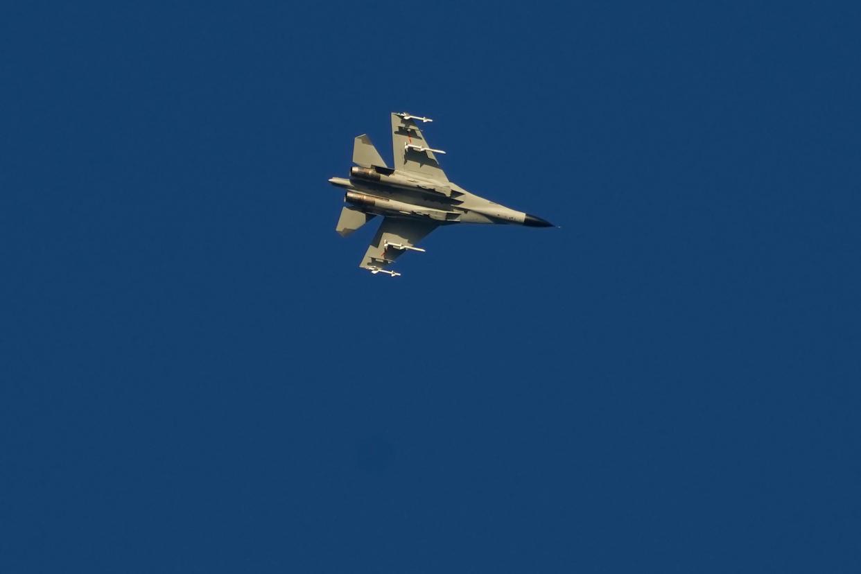 A military fighter jet flies above the Taiwan Strait as seen from the 68-nautical-mile scenic spot, the closest point in mainland China to the island of Taiwan, in Pingtan in southeastern China's Fujian Province, Friday, Aug. 5, 2022. 