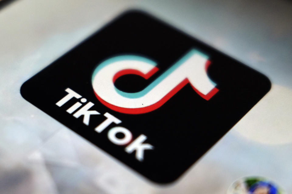 FILE - The TikTok app logo is displayed on a screen, Sept. 28, 2020, in Tokyo. A spokesperson for TikTok confirmed Tuesday, Jan. 23, 2024, that the social media platform is laying off dozens of workers in its advertising and sales unit, becoming the latest tech company to trim roles in the new year. (AP Photo/Kiichiro Sato, File)