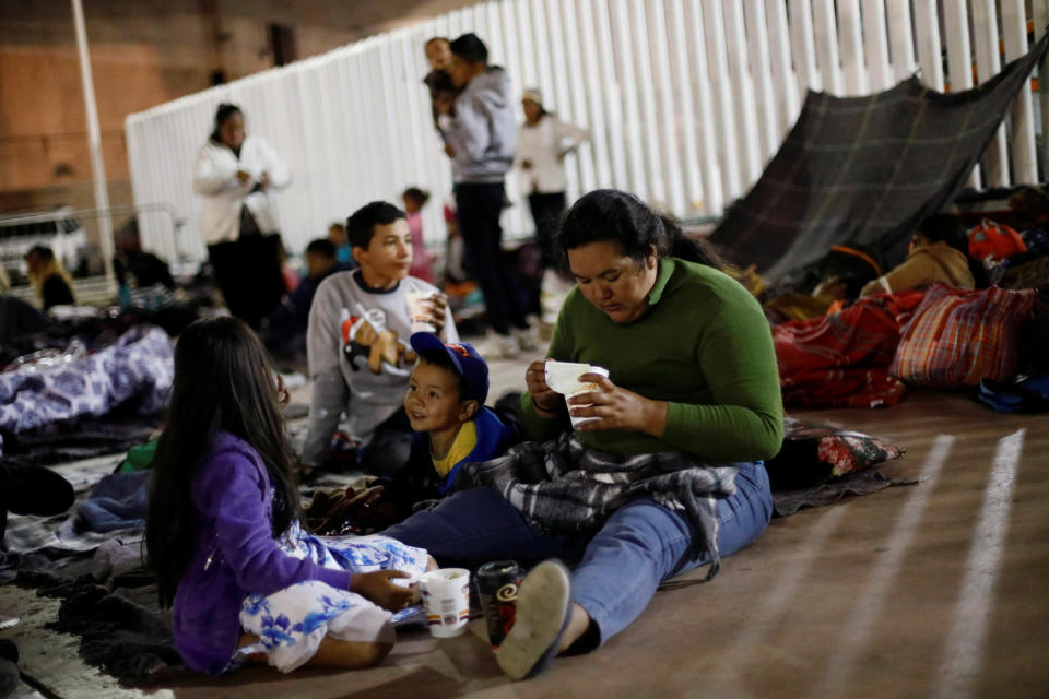 People get ready to spend the night near the San Ysidro checkpoint.