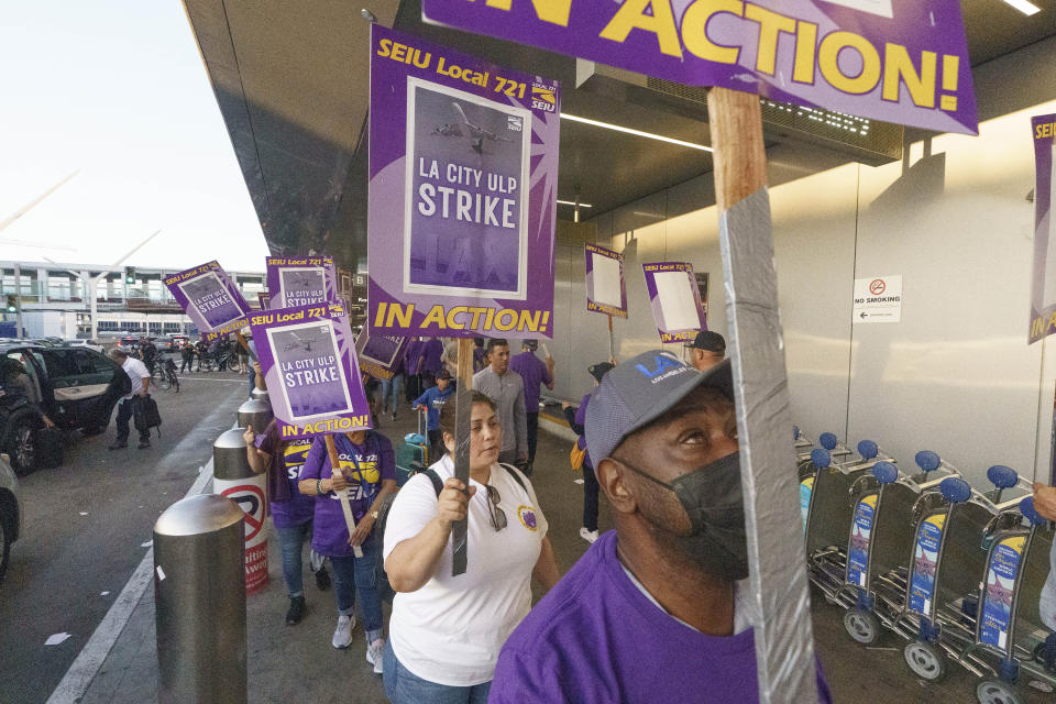 Workers with SEIU Local 721 - Southern California Public Service Workers join a picket line at the Los Angeles International Airport on Tuesday, Aug. 8, 2023. Thousands of Los Angeles city employees, including sanitation workers, engineers and traffic officers, walked off the job for a 24-hour strike alleging unfair labor practices. (AP Photo/Damian Dovarganes)