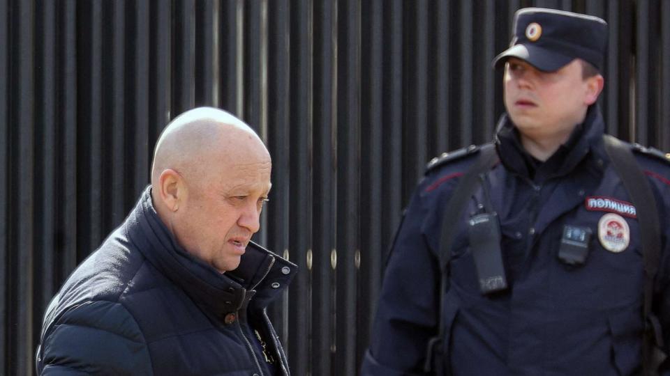 PHOTO: Founder of Wagner private mercenary group Yevgeny Prigozhin walks past a police officer in Moscow, April 8, 2023. (Yulia Morozova/Reuters, FILE)