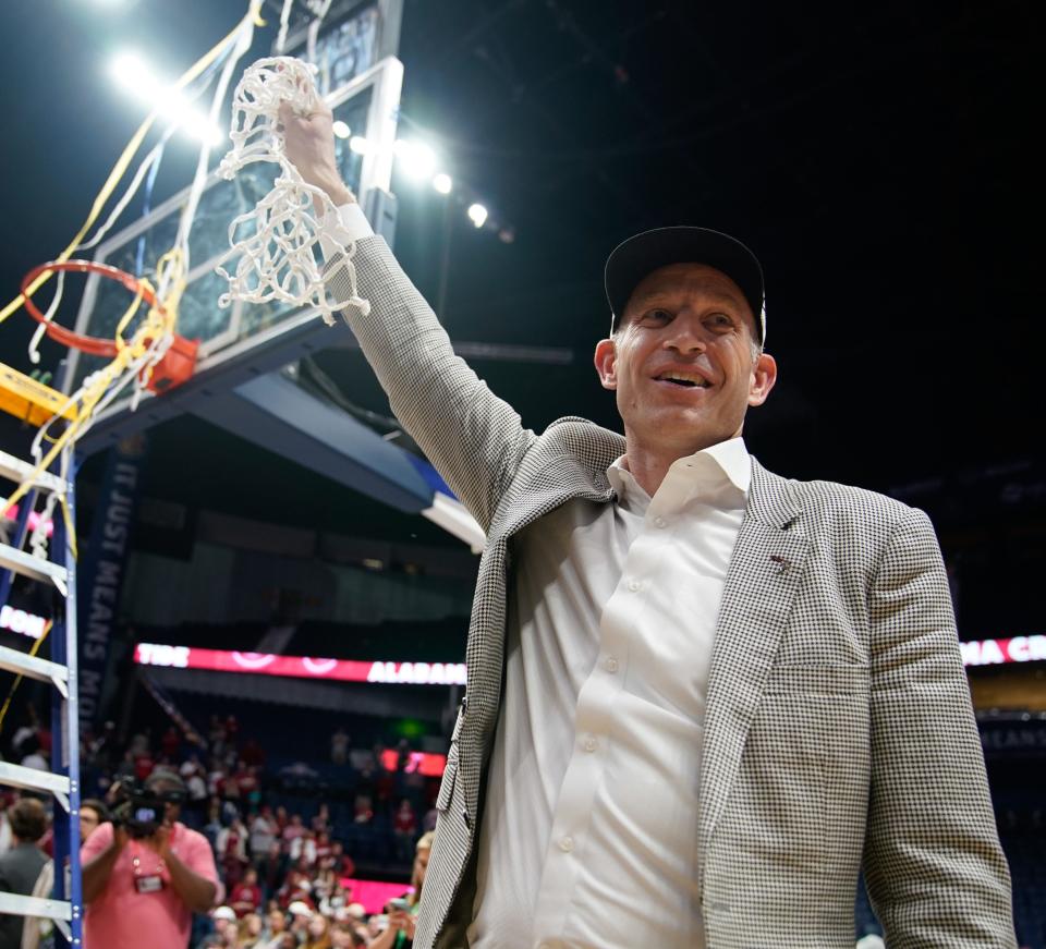 Alabama head coach Nate Oats leaves the court with the net after winning the championship SEC Men’s Basketball Tournament game over Texas A&M at Bridgestone Arena Sunday, March 12, 2023, in Nashville, Tenn. 