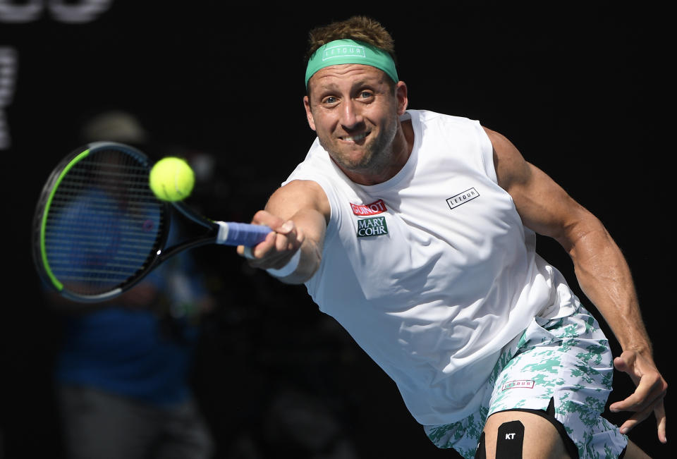 Tennys Sandgren of the U.S. makes a forehand return to Switzerland's Roger Federer during their quarterfinal match at the Australian Open tennis championship in Melbourne, Australia, Tuesday, Jan. 28, 2020. (AP Photo/Andy Brownbill)