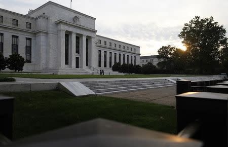 The sun rises to the east of the U.S. Federal Reserve building in Washington, July 31, 2013. REUTERS/Jonathan Ernst