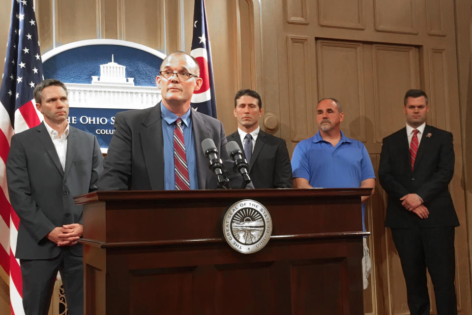 FILE-In a Tuesday, June 4, 2019 file photo, Roger Beedon discusses how sexual misconduct by now-deceased Ohio State team doctor Richard Strauss has affected his life, during a news conference with fellow Strauss accusers, from left, Brian Garrett, Dan Ritchie and Mike Flusche, and state Rep. Brett Hillyer, at the Statehouse in Columbus, Ohio. Beedon is among the men planning to appeal the dismissal of lawsuits they filed against Ohio State University over sexual abuse by the late team doctor Richard Strauss. Beedon says critics who question the plaintiffs' motives or think they're just after money don't understand what the survivors have been through and how it impacted their lives. (AP Photo/Kantele Franko, File)