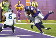 Minnesota Vikings wide receiver Adam Thielen (19) scores a touchdown on a catch in front of Seattle Seahawks strong safety Quandre Diggs (6) in the first half of an NFL football game in Minneapolis, Sunday, Sept. 26, 2021. (AP Photo/Bruce Kluckhohn)