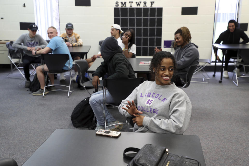 Fikirte Mott, foreground, and other students sit in a business class at Lincoln College, Tuesday, April 12, 2022, in Lincoln, Ill. The historically Black college in central Illinois named after Abraham Lincoln and founded the year the former president was assassinated will close this week, months after a cyberattack that compounded enrollment struggles due to the coronavirus pandemic. (Terrence Antonio James/Chicago Tribune)/Chicago Tribune via AP)