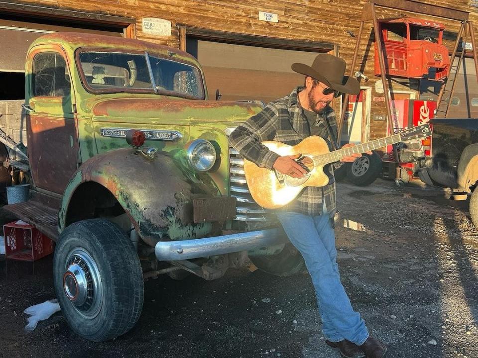 Singer-songwriter Skip Ewing plays his guitar at his home in Wyoming.