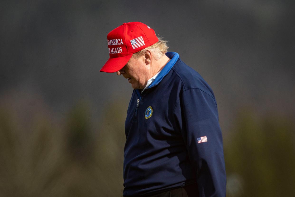 <p>Donald Trump, pictured playing golf on Sunday, retweeted a message accusing Joe Biden of ‘pretending’ to win the election</p> (Getty Images)
