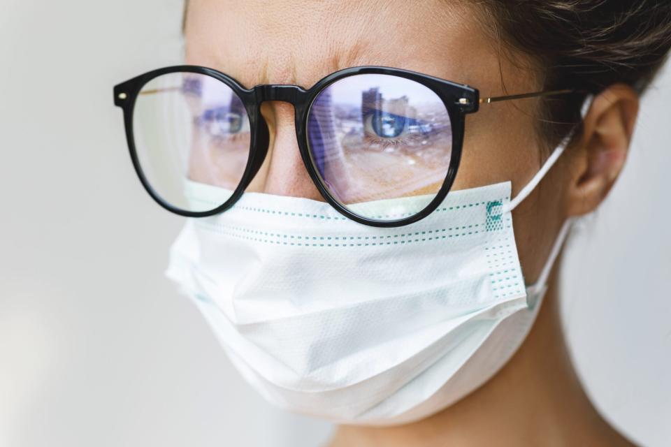 woman wearing glasses and a face mask