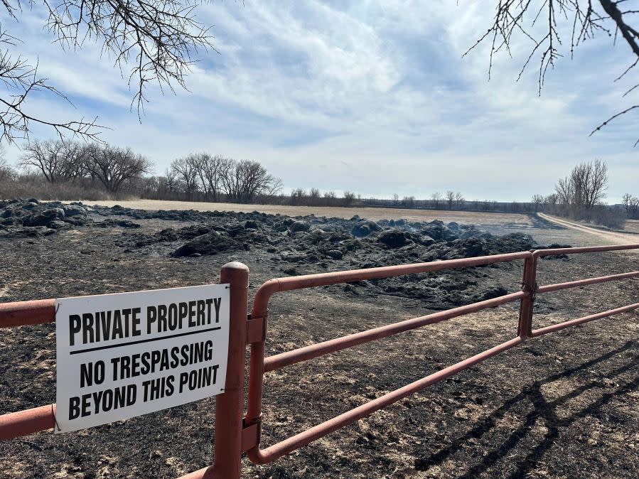 Smoke rises from smoldering hay bales outside the town of Canadian, Texas on Wednesday, Feb 28, 2024. A fast-moving wildfire burning through the Texas Panhandle grew into the second-largest blaze in state history Wednesday, forcing evacuations and triggering power outages as firefighters struggled to contain the widening flames.(AP Photo/Sean Murphy)