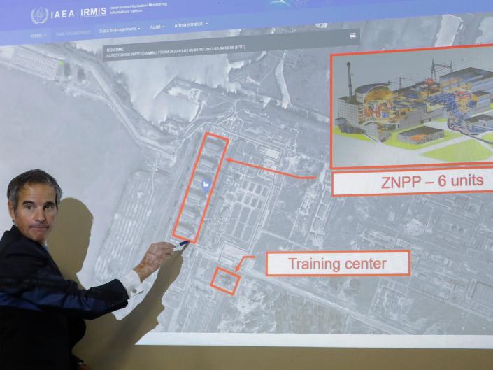 Rafael Mariano Grossi points to a diagram showing the Zaporizhzhia Nuclear Power Plant in Ukraine