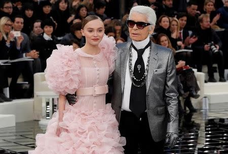 German designer Karl Lagerfeld appears with actress and model Lily-Rose Depp at the end of his Haute Couture Spring/Summer 2017 fashion show for Chanel in Paris, France, January 24, 2017. REUTERS/Gonzalo Fuentes/File Photo