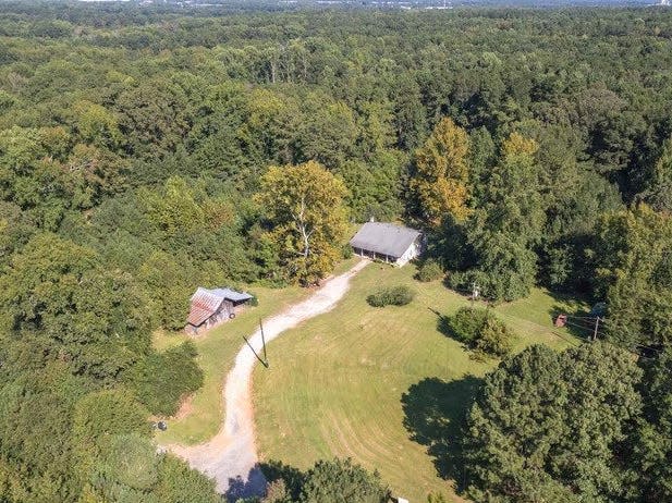 a small house from above in a forest