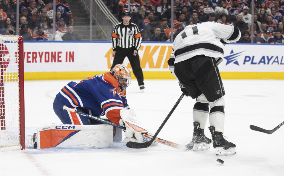 Los Angles Kings' Anze Kopitar (11) is poke-checked by Edmonton Oilers goalie Stuart Skinner (74) during first-period NHL hockey game action in Edmonton, Alberta, Monday, Feb. 26, 2024. (Jason Franson/The Canadian Press via AP)