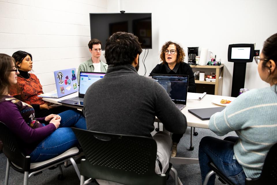 Claire Frances, second from right, talks with collaborators during an Iowa Intersections meeting, Monday, Dec. 5, 2022, at Phillips Hall on the University of Iowa campus in Iowa City, Iowa.