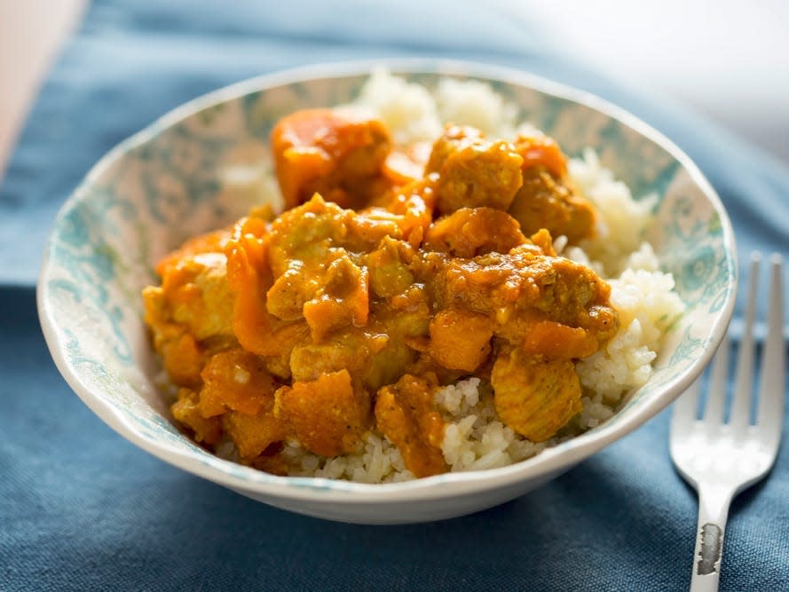 turkey curry in a bowl with rice