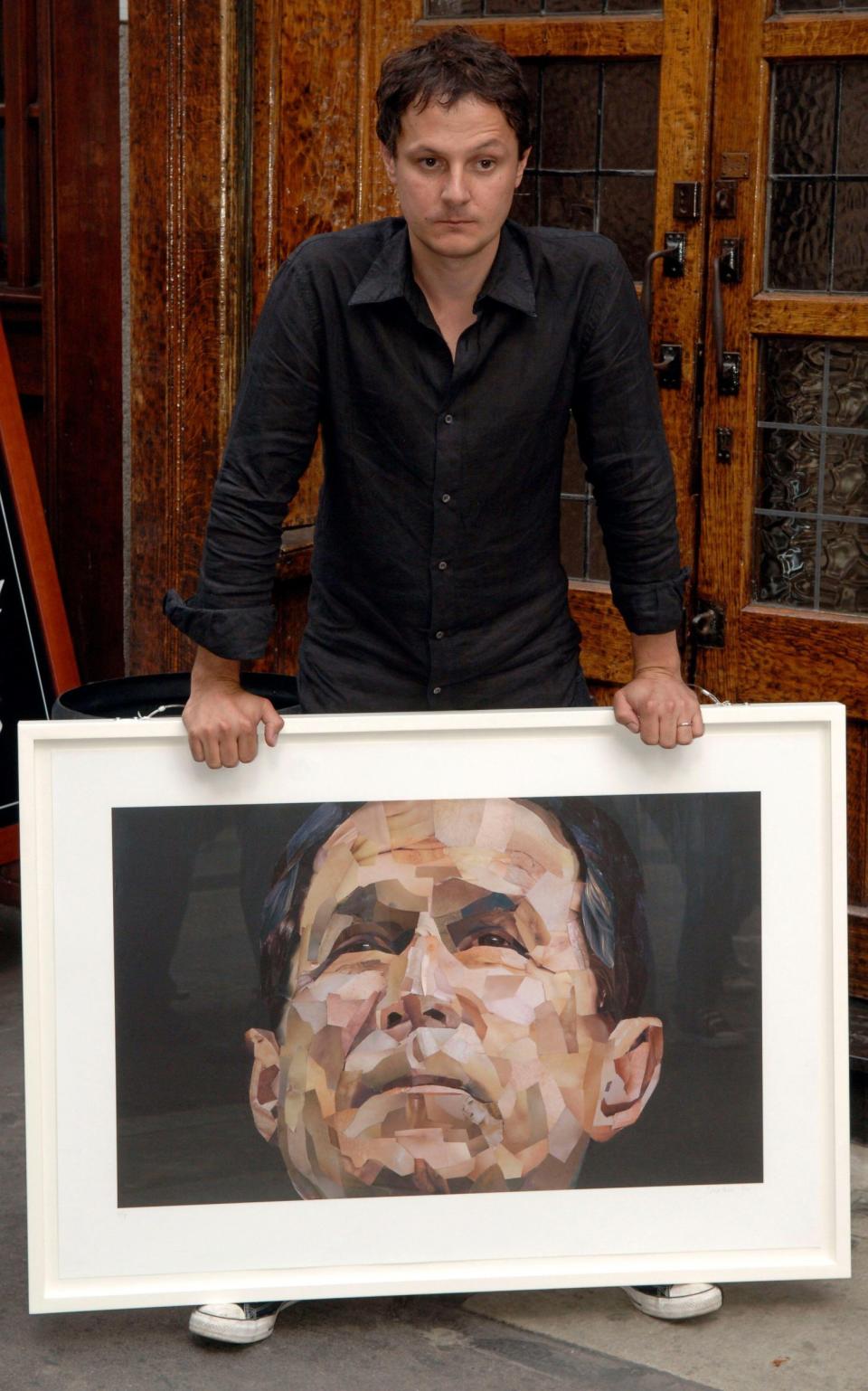 Yeo unveiling the controversial collage portrait of US president George W Bush