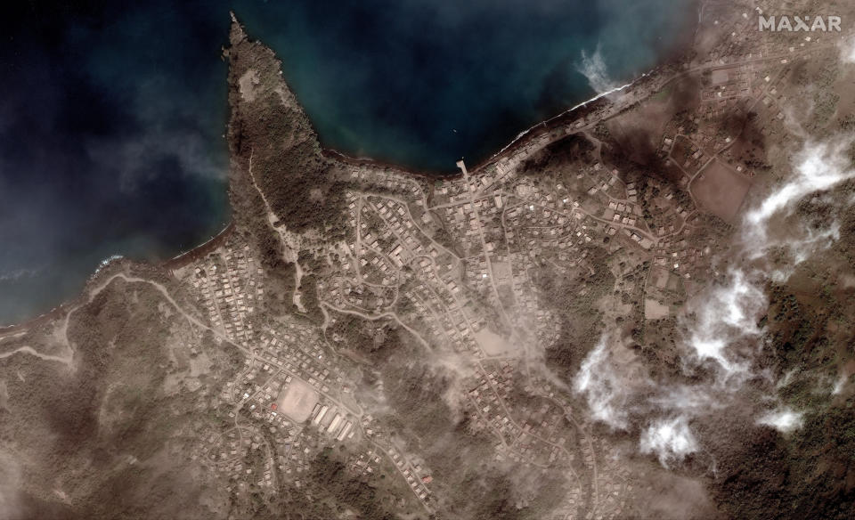 This image provided by Maxar Technologies shows the Richmond Vale waterfront covered in volcanic ash, in Chateaubelair, St. Vincent, Tuesday, April 13, 2021, a day after after another eruption of the La Soufriere volcano. St. Vincent is the biggest of the islands forming St. Vincent and the Grenadines, which gained independence from Britain in 1979 and has a population of about 110,000. (Satellite image ©2021 Maxar Technologies via AP)