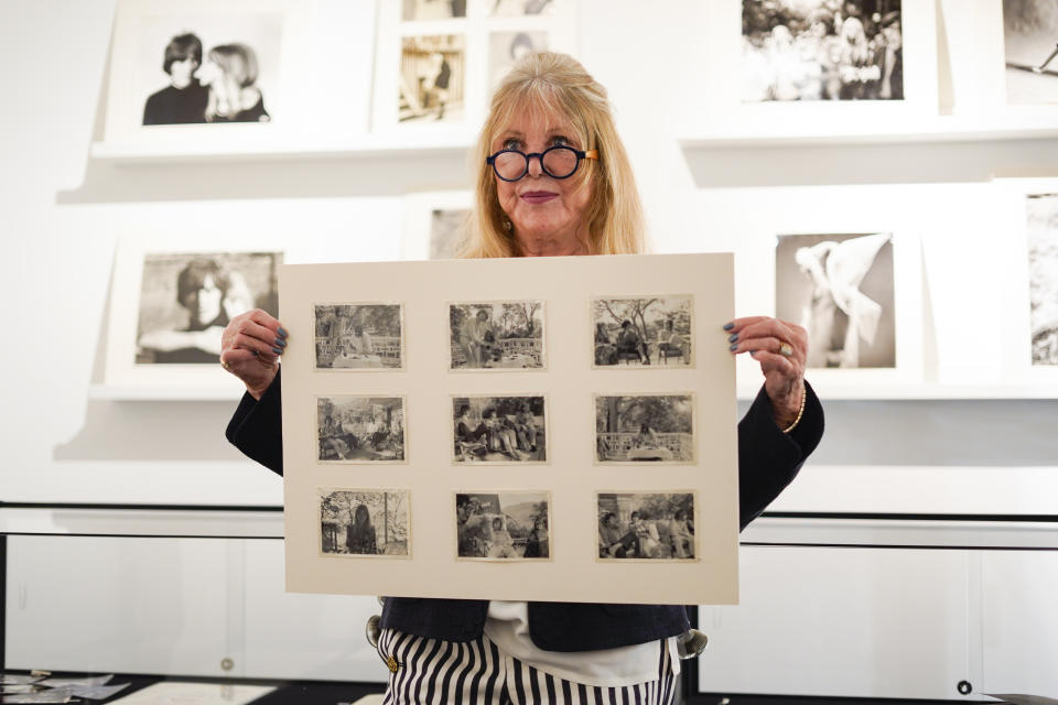 Pattie Boyd holds a set of pictures she took during the Beatles' travel in India from The Pattie Boyd Collection, at Christie's, in London, Thursday, March 14, 2024. The photographs are estimated to sell within a range of £3,000-5,000. (AP Photo/Alberto Pezzali)