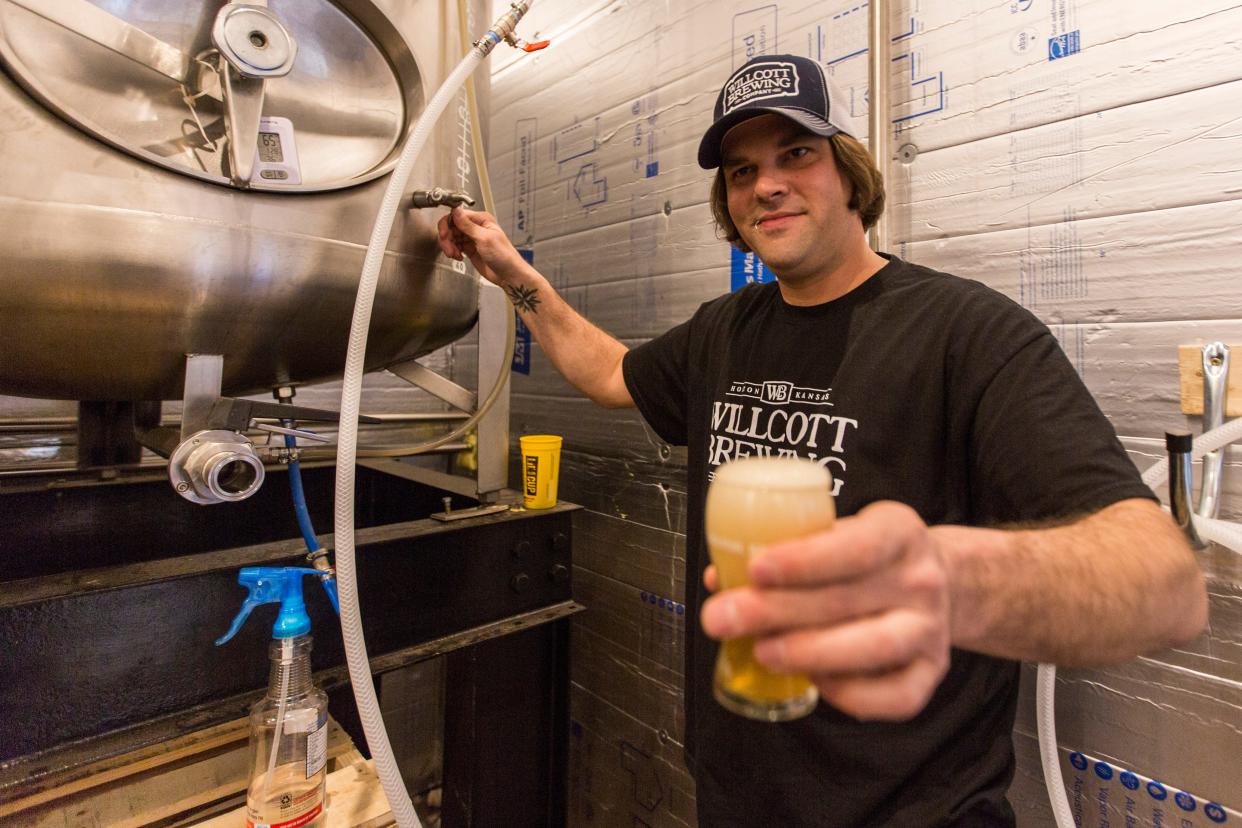 Will Heinen, brewer at Willcott Brewing Company in Holton, holds a beer poured straight from the tank. Willcott Brewing helped organize brewers around the state to change distribution laws for craft brewers.