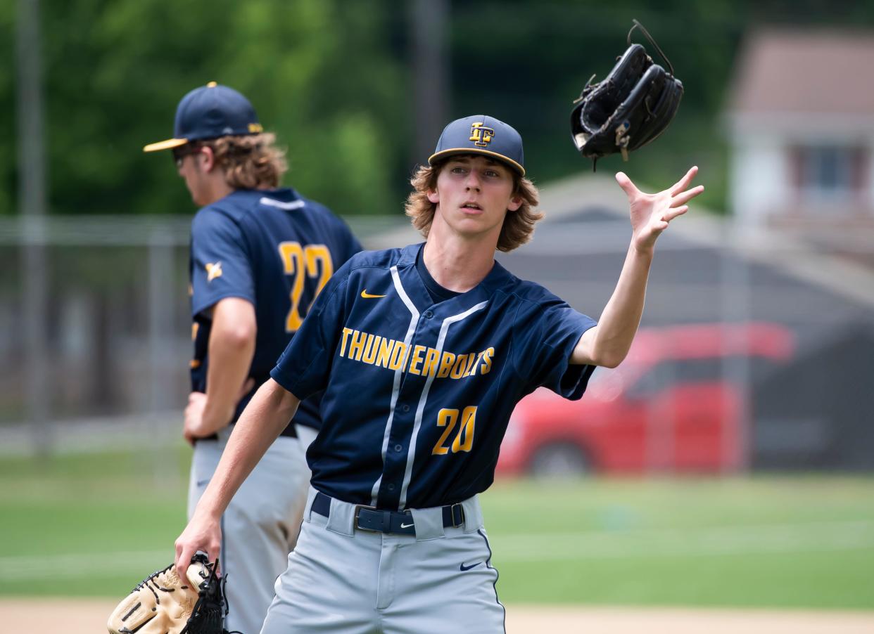 Littlestown's Colby Hahn switches out gloves as he moves from center field to pitcher during the District 3 Class 4A championship in 2022.