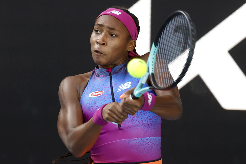 Coco Gauff of the U.S. plays a backhand return to Wang Qiang of China during their first round match at the Australian Open tennis championships in Melbourne, Australia, Monday, Jan. 17, 2022. (AP Photo/Hamish Blair)