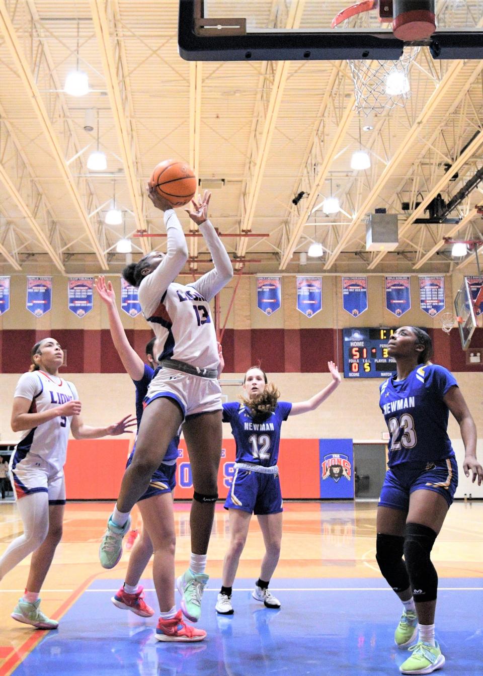 King's Academy's Jade Jones goes up for a layup against Cardinal Newman in the Lions' district title game against the Crusaders on Feb. 3, 2023.