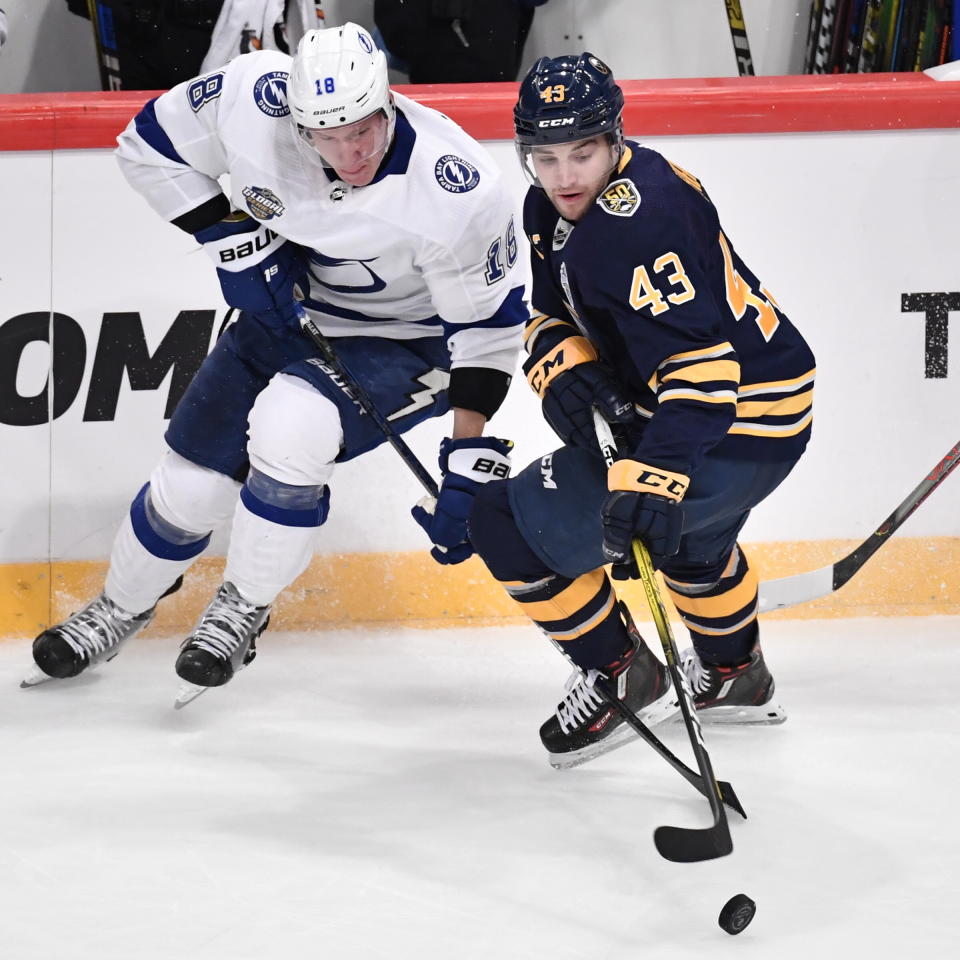 Tampa Bay Lightning's Ondrej Palat, left, and Buffalo Sabres' Conor Sheary (43) battle for the puck during an NHL hockey game in Globen Arena, Stockholm Sweden. Friday. Nov. 8, 2019. (Anders Wiklund/TT via AP)