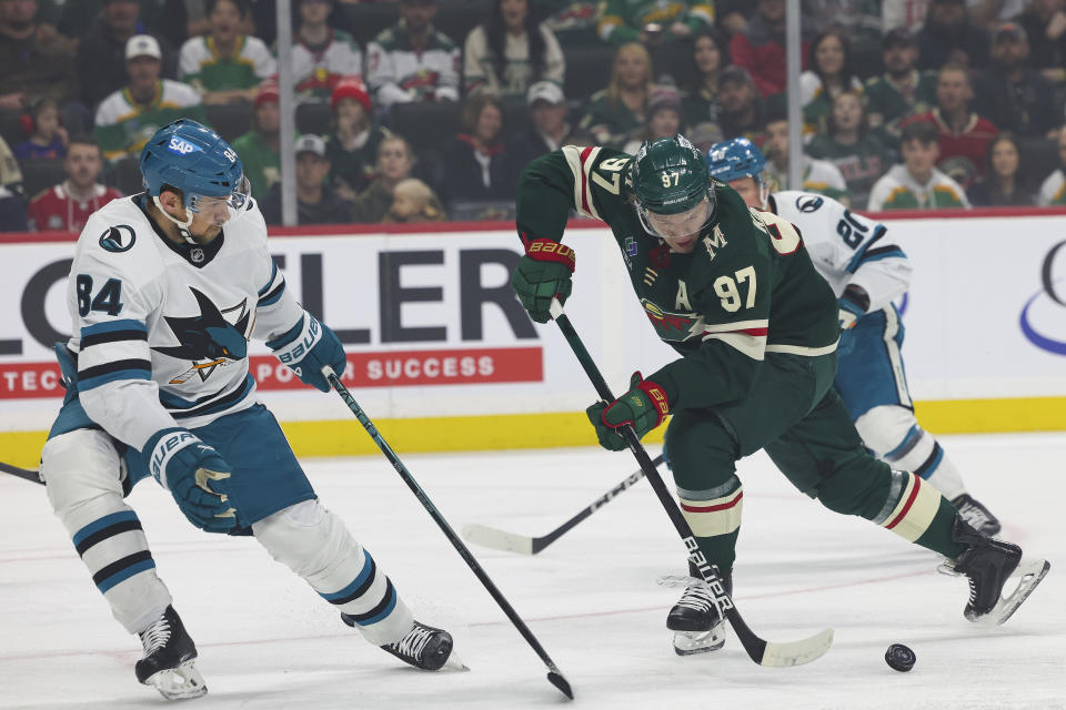 Minnesota Wild left wing Kirill Kaprizov (97) moves the puck against San Jose Sharks defenseman Jan Rutta (84) during the first period of an NHL hockey game, Sunday, March 3, 2024, in St. Paul, Minn. (AP Photo/Stacy Bengs)