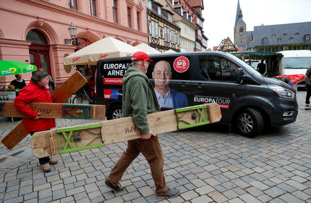 Supporters of Arne Lietz, candidate of the Social Democratic Party (SPD) for the upcoming European Parliament elections carry benches in Quedlinburg, Germany, May 4, 2019. Picture taken May 4, 2019. REUTERS/Fabrizio Bensch