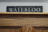 A sign sits on a shelf in the office of Waterloo Mayor Quentin Hart, Tuesday, Sept. 7, 2021, in Waterloo, Iowa. Joel Fitzgerald, the first Black police chief in Waterloo, is facing intense opposition from some current and former officers as he works with city leaders to reform the department, including the removal of its longtime insignia that resembles a Ku Klux Klan dragon. (AP Photo/Charlie Neibergall)