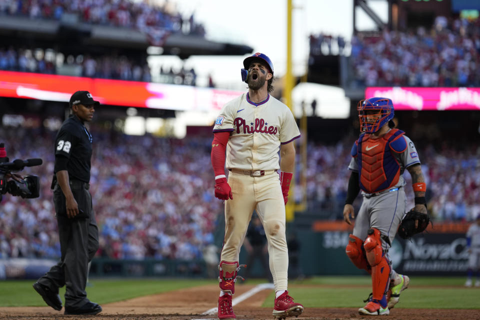 Philadelphia Phillies' Bryce Harper reacts after hitting a two-run home run against New York Mets pitcher Luis Severino during the sixth inning of Game 2 of a baseball NL Division Series, Sunday, Oct. 6, 2024, in Philadelphia. (AP Photo/Matt Slocum)