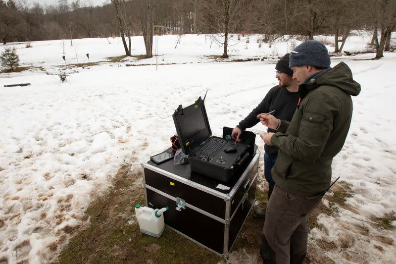 Timothy De Smet and Alex Nikulin prepare a Ukrainian Multirotor Technologies (UMT) Cicada-M drone to fly with a magnetometer to detect abandoned oil wells in Olean, New York