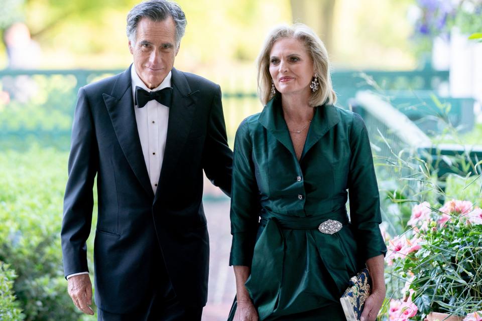 Romney and his wife Ann, seen here at a White House state dinner in April, have helped shape the public perception of Latter-Day Saints. | AFP via Getty Images