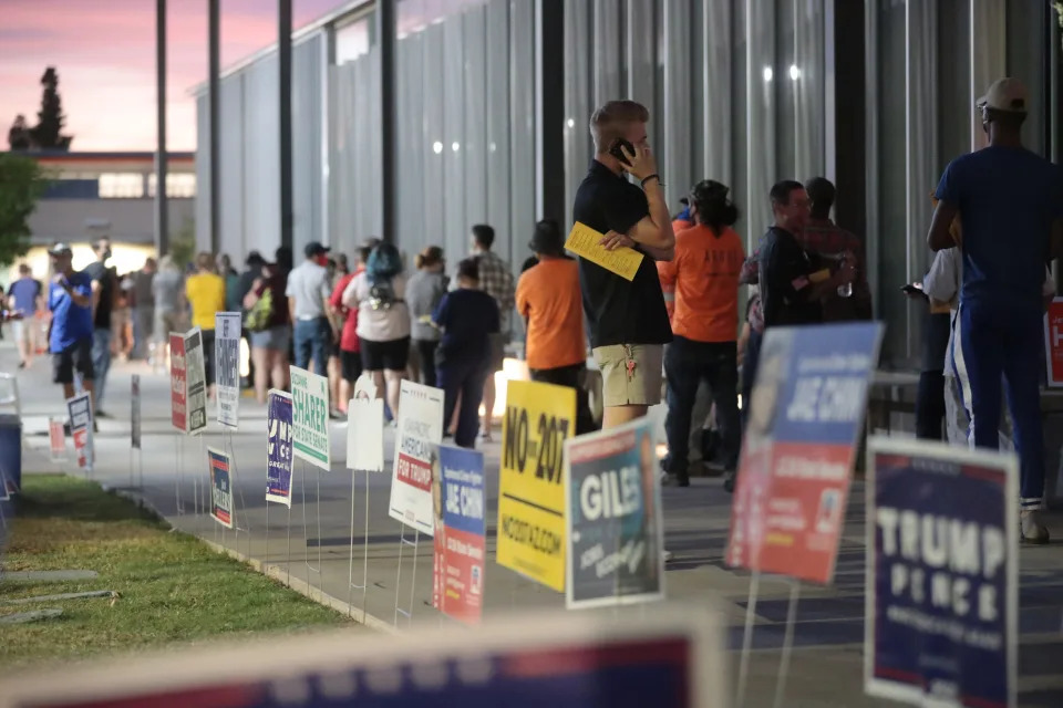 Voters wait in line at a polling station at Mesa Community College in Mesa, Ariz. on Election Day.