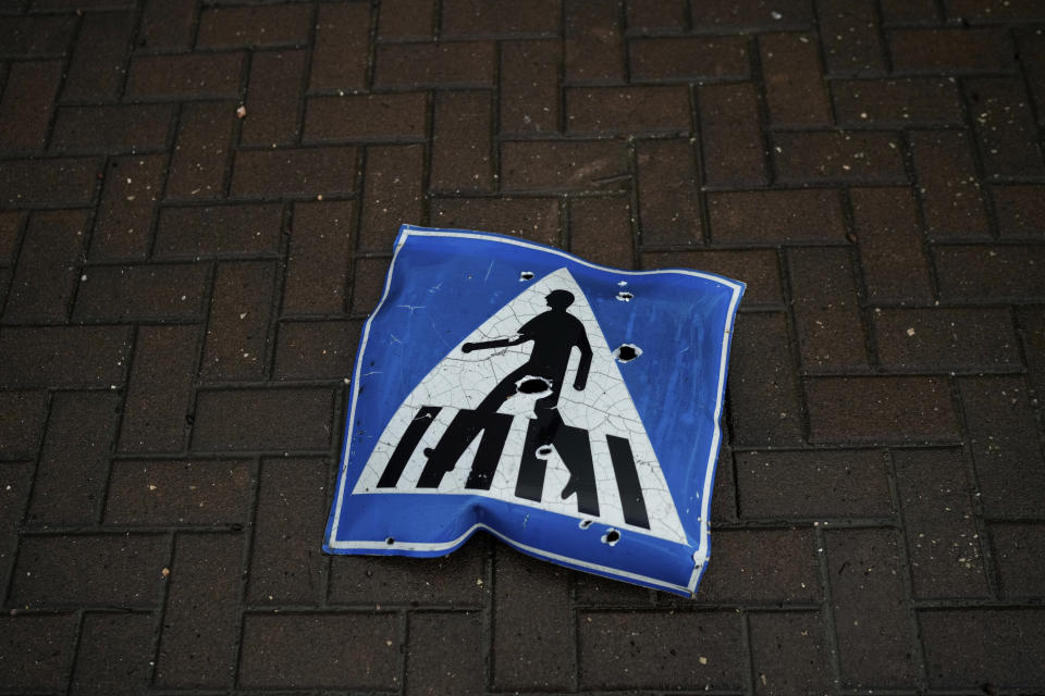 A pockmarked traffic sign lies on the ground at a site hit by rocket fire from Lebanon in Kiryat Shmona, northern Israel, Thursday, Jan. 11, 2024. (AP Photo/Leo Correa)