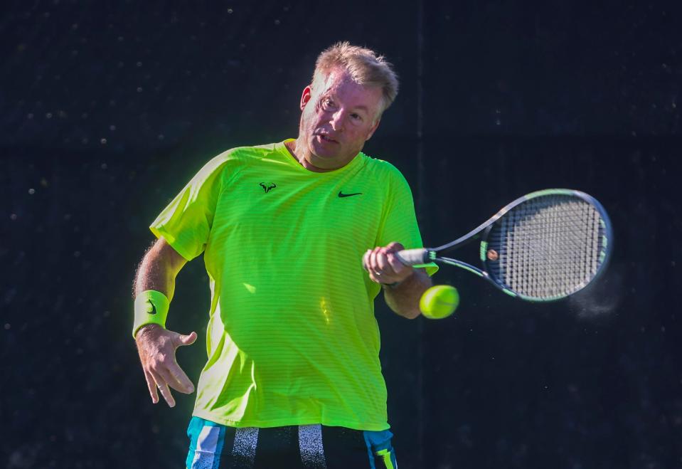 Sam Garton returns a shot at the Phipps Ocean Park Tennis Center while playing doubles with friends in April. DAMON HIGGINS / PALM BEACH DAILY NEWS